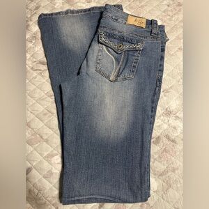Boot cut distressed blue jeans
